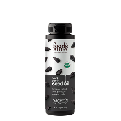 An 8 fl oz bottle of Foods Alive Black Cumin Seed Oil on a solid white background. The bottle is black with a white and black label featuring illustrations of cumin seeds and a USDA Organic seal.